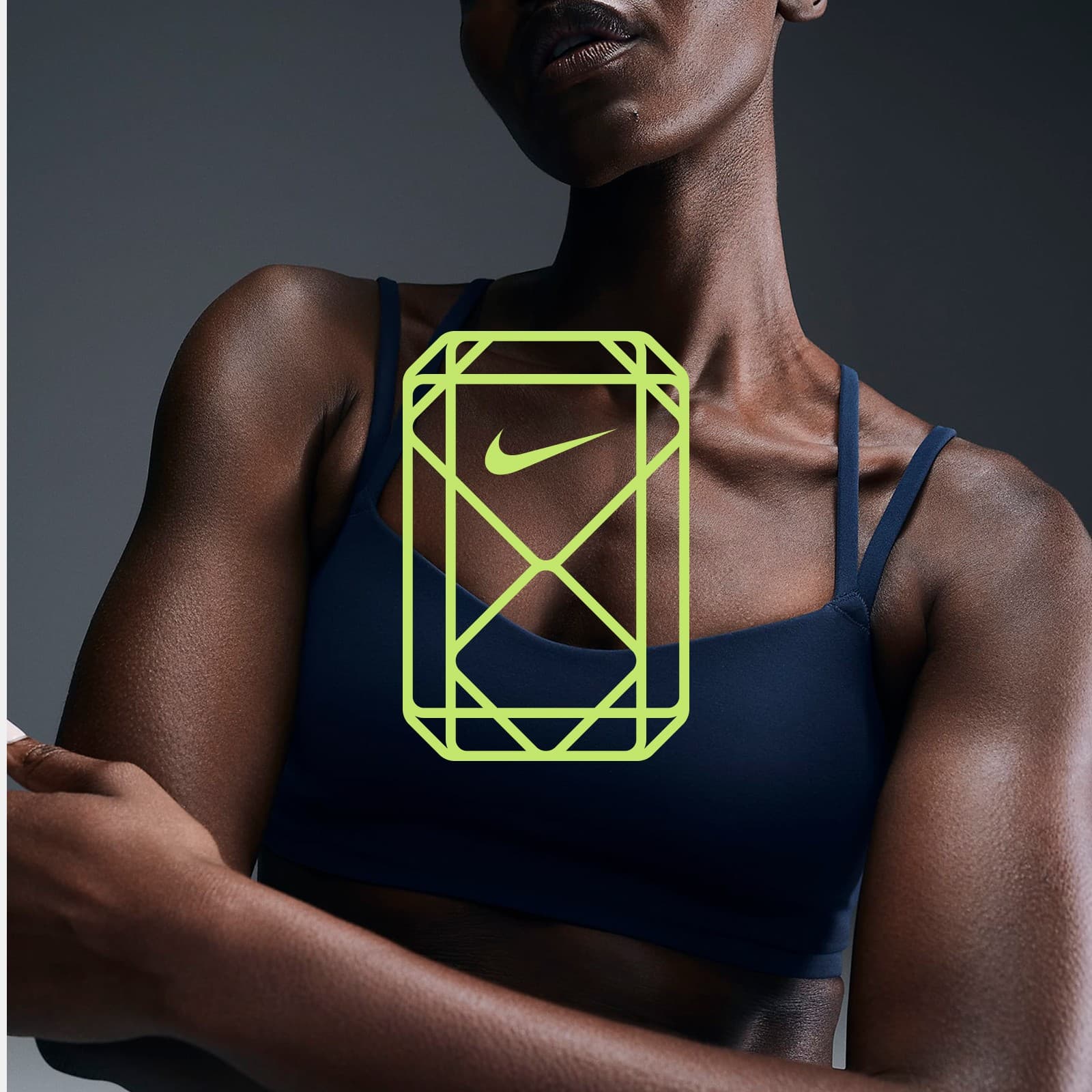 The gemstone mark in volt yellow over an athlete in a navy sports bra