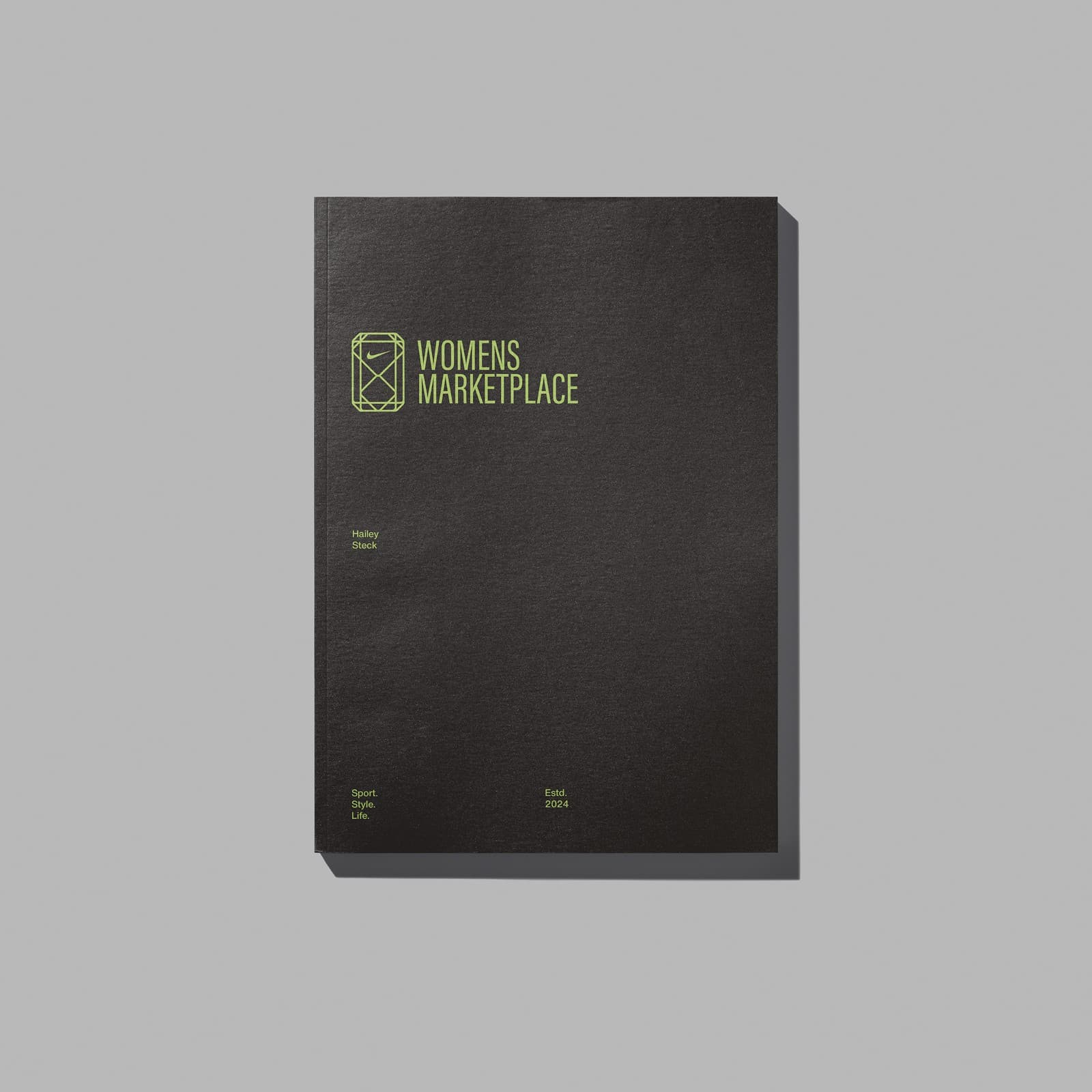Black notebook with the Women's Marketplace wordmark